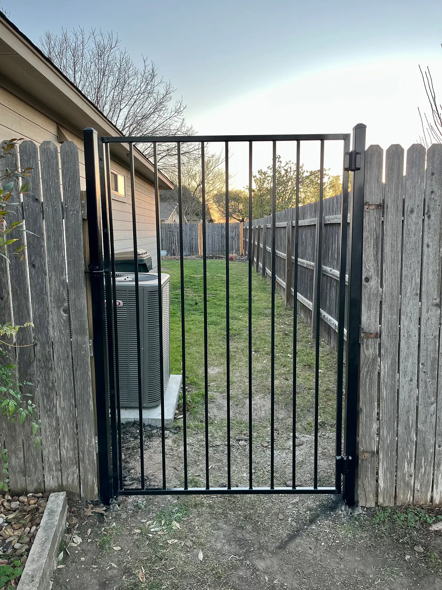 Wrought iron gate in a wood privacy fence